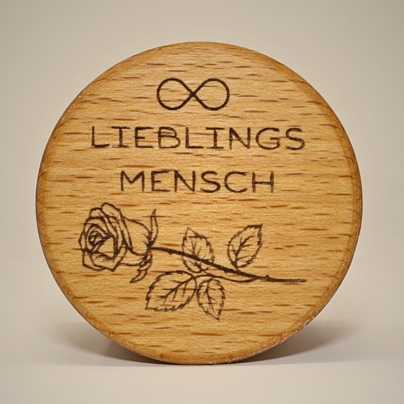 Eine MEMENTOVIA-Box in der Draufsicht mit einem Motiv aus einem Unendlichzeichen und einer Rose sowie dem Schriftzug "Lieblingsmensch"